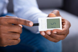 Close up of man's hand taking blood sugar