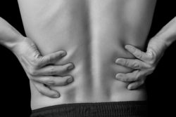 Man holding kidneys in pain