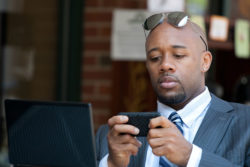A man looks at his mobile phone.