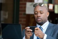 A man looks at his mobile phone.