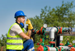 A worker talks on a two way radio.