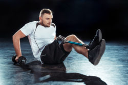A man exercises with a prosthetic leg.