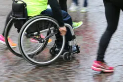 A person in a wheelchair participates in an organized run.
