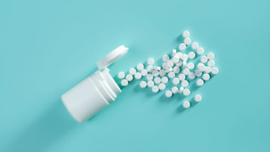 White pills on blue background