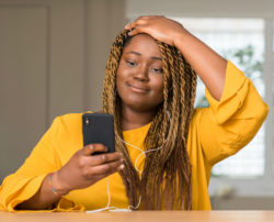 A woman is frustrated with her malfunctioning smartphone.