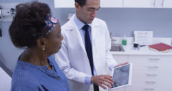 A woman and her doctor looking at mri scans.