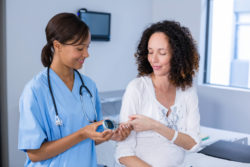 Woman getting a blood sugar test.