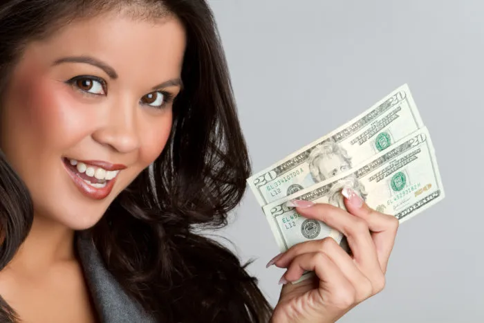 woman holding money from settlement checks