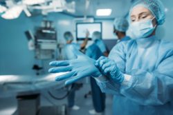 Woman with glove in operating room
