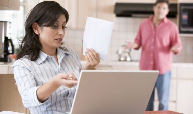 A woman is concerned about something in her bank statement.