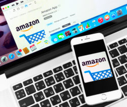 amazon app on smartphone and Amazon website open on a laptop computer from consumer checking out amazon reviews