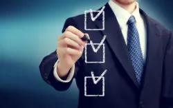 Businessman checking boxes