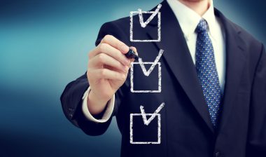 Businessman checking boxes