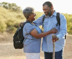 A couple walks on the beach.