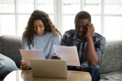 A couple worries over their bank statements.