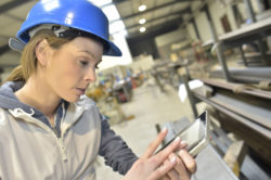 An engineer works on a tablet.