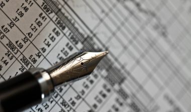 Close-up pf fancy pen and financial papers.