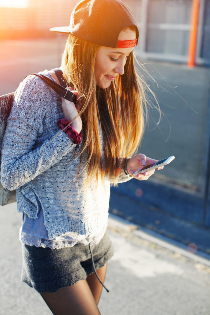 girl getting text from mid-