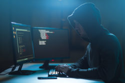 A hacker works on computers.