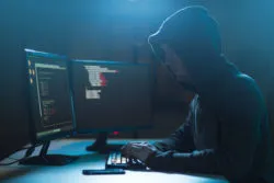 A hacker works on computers.
