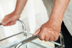 Close up of hands holding a walker