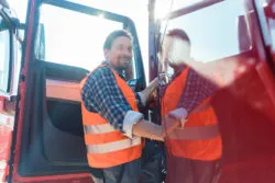 Long haul trucker gets into cab