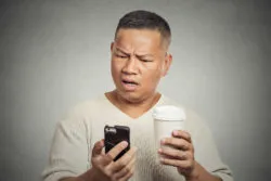 Man gets bad news on his smart phone.