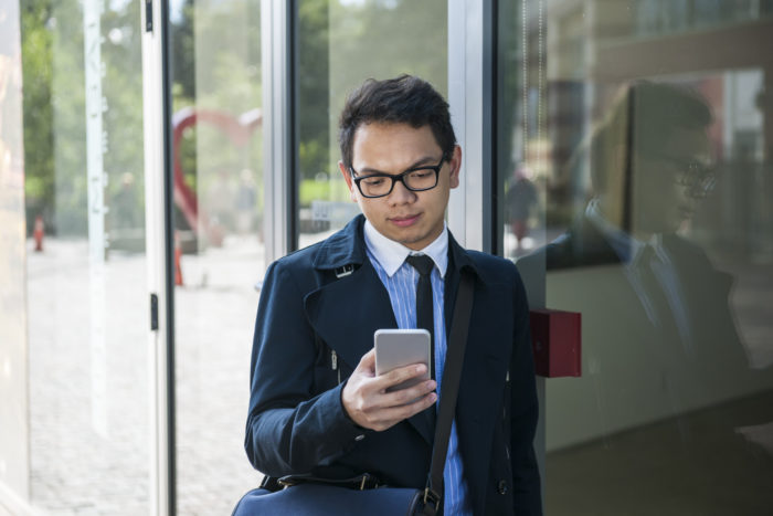 man looking at phone receiving a telemarketing call from modernized