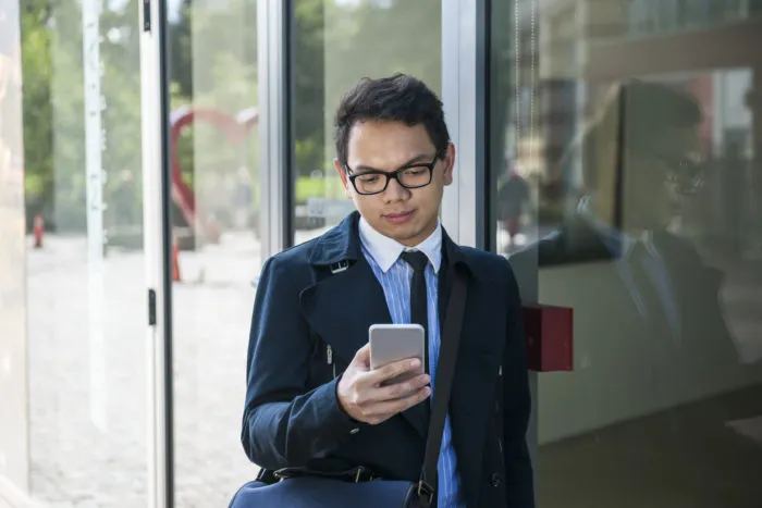 man looking at phone receiving a telemarketing call from modernized