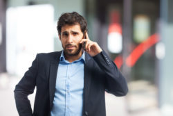 A man talks on a phone.