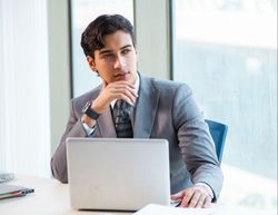 A man in an office looks concerned.