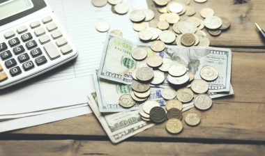 Money and calculator on papers