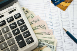 Money, calculator, credit cards and bank statements