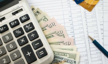 Money, calculator, credit cards and bank statements
