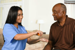 A nurse helps a patient.