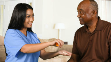 A nurse helps a patient.