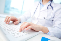 doctor or nurse inputing patient information on the UCLA Health computer network