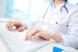 doctor or nurse inputing patient information on the UCLA Health computer network