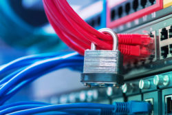 A padlock on networking cables on a computer