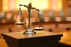 Scales sit on a lectern in a courtroom.