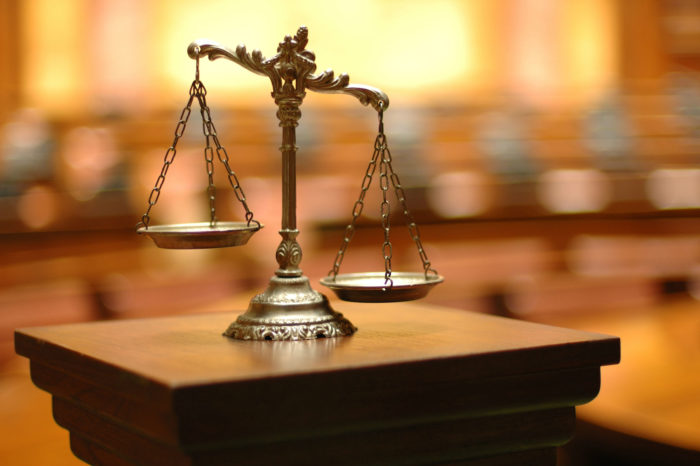 Scales sit on a lectern in a courtroom.
