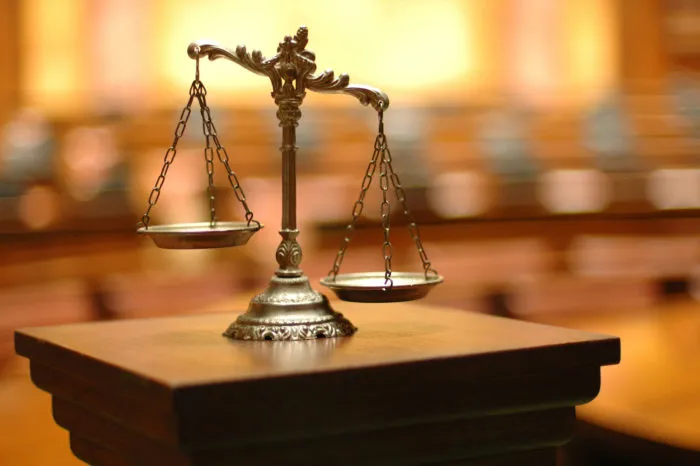 Scales sit on a lectern in a courtroom.
