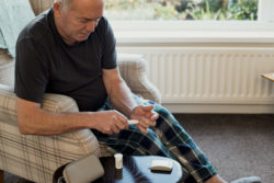 Senior man checks blood sugar