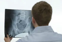 Tech analyzes a hip mri