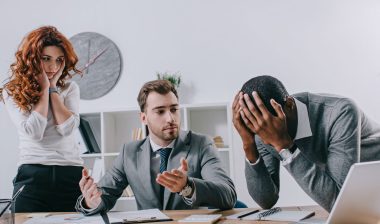 Three bank employees look worried.