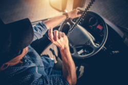 A truck driver talks on a CB.
