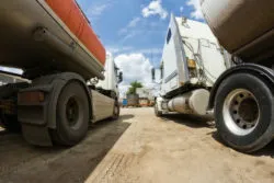 Two semi trucks in a yard