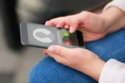 A smartphone shows an unknown number for an incoming call.