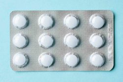 White pills on blue background