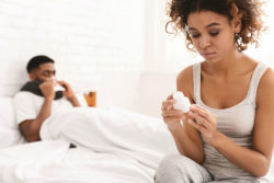 Woman looks at bottle of pills